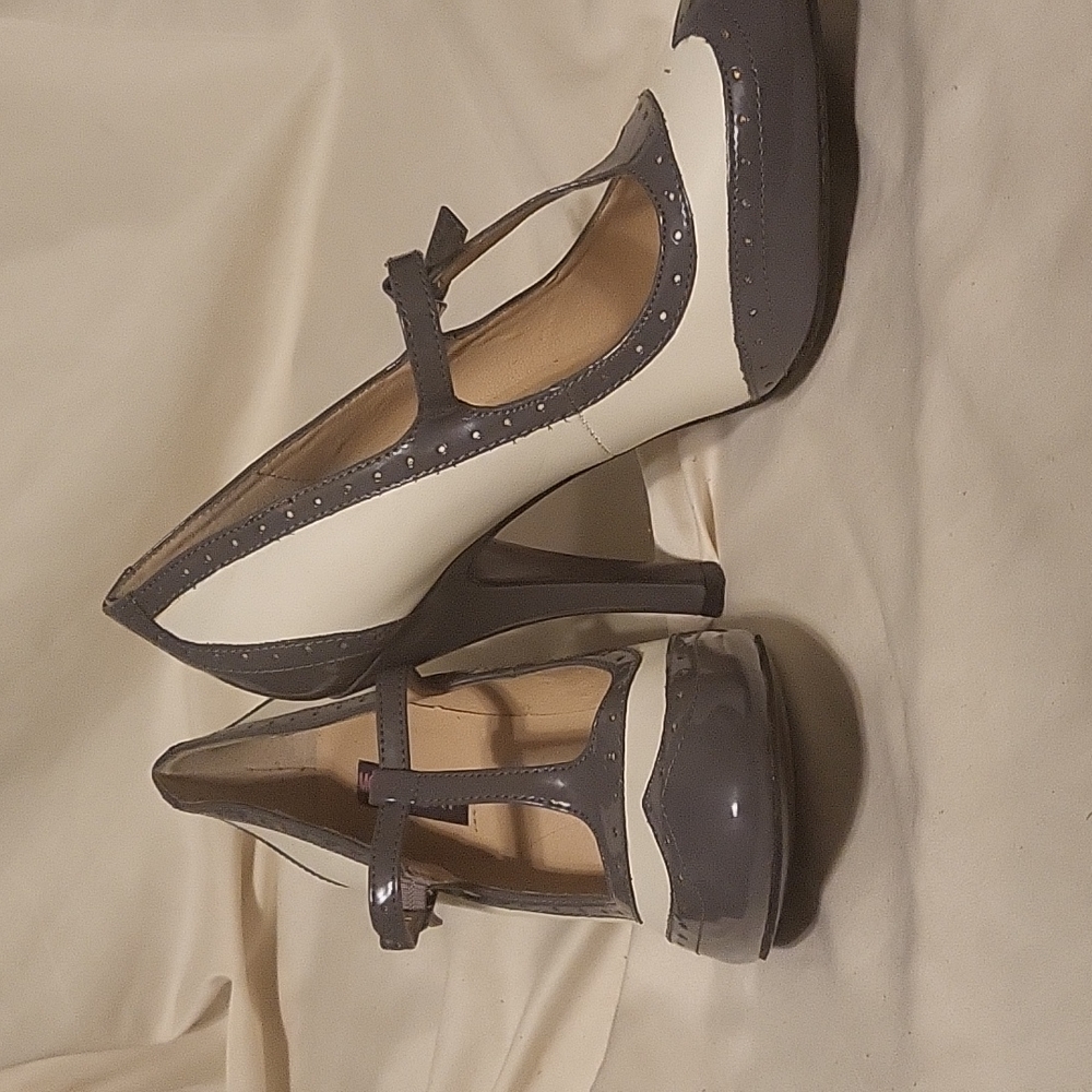 A pair of gray and white Dolce heels